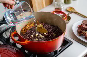 Add beans and meats to aromatics