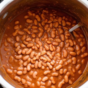 show a large pressure cooker pot with extra saucy and creamy pinto beans